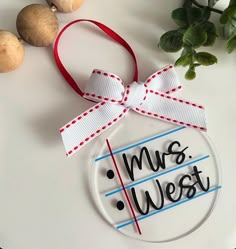 a glass ornament that says mr and mrs west on it next to some vegetables