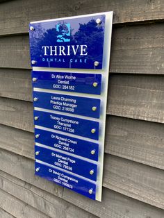 a sign on the side of a building that says thrive dental care