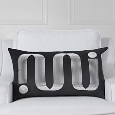 a black and white pillow with the letter u on it