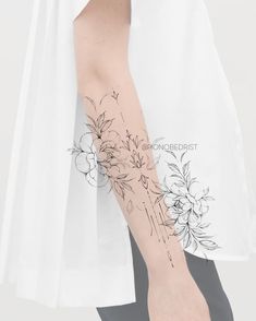 a woman's arm with flowers on it