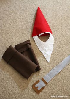 an elf's hat is laying on the floor next to a piece of paper