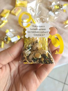 someone holding up a bag of mushrooms in front of a table full of yellow and white confetti