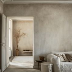 a white couch sitting next to a window in a living room