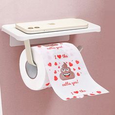 a roll of toilet paper hanging on a wall next to a cell phone with the word i love you printed on it