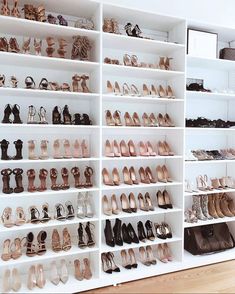 there are many pairs of shoes on the shelves