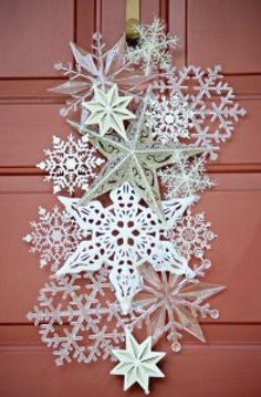 an ornament hanging from the side of a door with snowflakes on it