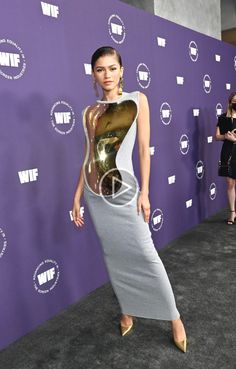 an image of a woman in a dress on the red carpet at w e f