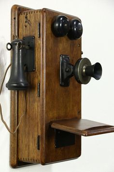 an old fashioned telephone with two bells on it's side and a shelf for the phone