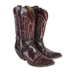 Vintage Cowboy Boots by D'Jesus are a striking addition to your wardrobe, handcrafted in Mexico with oxblood red leather and intricate detailing. These Western-style boots feature pointed toes and a mid-calf shaft, making them perfect for a variety of occasions from casual outings to parties. The thick stitching, and exotic skin accents add a touch of authenticity and style to these unique boots. Step out in true cowboy fashion with these one-of-a-kind boots that exude a blend of Mexican, Wester Cowboy Leather Boots, Old Cowboy Boots, Cowboy Boots Vintage, Cowboy Fashion, Thick Stitching, Cowboy Vintage, Red Cowboy Boots, Cowboy Shoes, Unique Boots