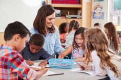 an adult teacher teaching children in a classroom stock photo edit now, image is not available for commercial use at this time