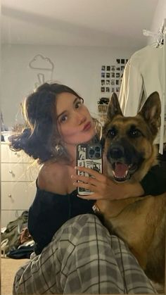 a woman taking a selfie with her dog