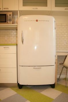 a white refrigerator freezer sitting inside of a kitchen