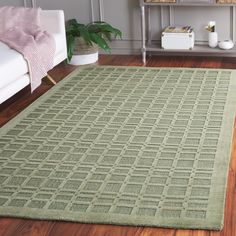 a green area rug in a living room