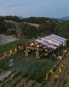 an aerial view of a wine tasting venue in the middle of a vineyard at dusk