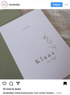 a close up of an open book on top of a bed with the word klaas printed on it