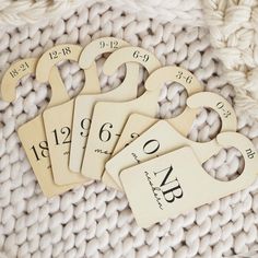 four wooden tags with numbers on them sitting on a blanket