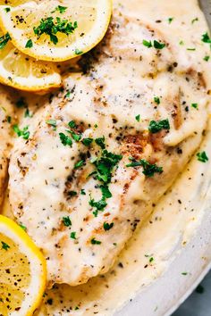 chicken breast with lemon sauce and parsley on top, served in a white bowl