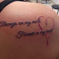 a woman with a tattoo on her back saying, always on my mind forever in my heart