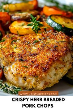 crispy herb breaded pork chops on a white plate with carrots and zucchini