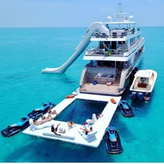 a large boat floating in the ocean next to a slide that looks like a water slide