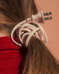 a woman with her hair pulled back and plugged in to an outlet for the phone