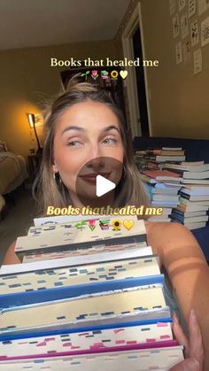 a woman holding stacks of books in front of her face and the caption reads books that healed me