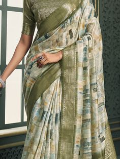 Introducing our exquisite off-white and olive green cotton saree, a perfect blend of traditional charm and contemporary elegance. This saree is crafted with meticulous attention to detail, featuring intricate digital print work that adds a modern touch to its classic design. The rich weaving pallu and the intricately designed weaving border enhance its regal appearance, making it a timeless piece suitable for any occasion. The soft cotton fabric ensures maximum comfort, allowing you to drape it Green Digital Print Saree For Wedding, Green Digital Print Wedding Saree, Green Digital Print Saree With Motifs, Green Cotton Saree With Printed Border, Festive Green Digital Prints With Printed Border, Green Cotton Silk Saree With Printed Motifs, Green Cotton Silk Saree With Block Print, Green Block Print Cotton Silk Saree, Green Cotton Silk Saree With Printed Border