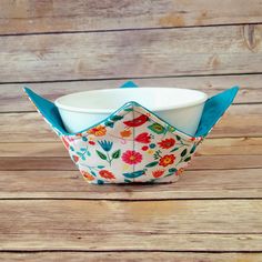 an origami bowl sitting on top of a wooden table