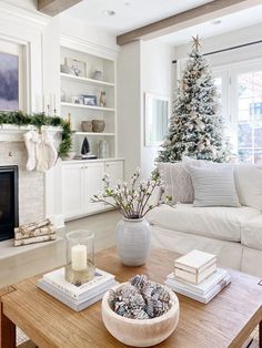 a living room filled with furniture and a christmas tree in the middle of the room