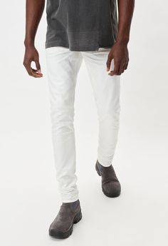 Japanese 3x1 woven stretch denim in white. Unwashed, raw denim with 3D whiskering and tonal stitching. Slim tapered fit with a low rise in the front and higher rise in the back. Made in Japan. 98% Cotton / 2% Poly. John Elliott, Raw Denim, The Cast, Made In Japan, Stretch Denim, Low Rise, Stitching, It Cast, Slim Fit