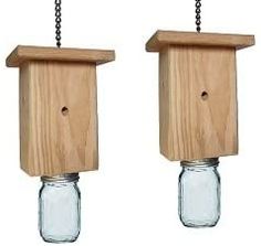 two mason jars with chains hanging from them, one is empty and the other has a birdhouse in it