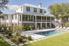 a large white house with a pool in the yard