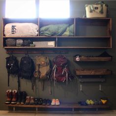 there are many backpacks and shoes hanging on the wall