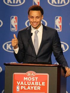 a man giving a thumbs up while standing at a podium