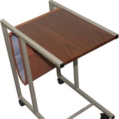 a wooden table with wheels and a magazine holder on it's side that is attached to a metal frame