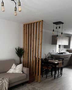 a living room filled with furniture next to a kitchen and dining room table in front of a sliding door