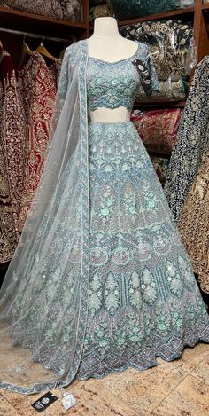 Powder blue craftsmanship with fine details of multicolor sequins, stone, pearl and cutdana nestled on sheer net fabric in floral embroidery bloom this lehenga. Includes a ready blouse paired with beautiful net dupatta. If you are planning to ace the grace of your D-day dress, then this Powder Blue is the best choice. Fabric: Net Size: 38/M Occasion: Wedding Ceremony or Reception WASH CARE INSTRUCTIONS - Please Dry clean only when it is applicable. Slight color variation is possible due to digit Pale Blue Lehenga, Festival Reception Lehenga With Intricate Design, Bollywood Style Lehenga For Wedding With Intricate Design, Bollywood Wedding Lehenga With Intricate Design, Fusion Style Wedding Sets For Festive Occasion, Fusion Style Festive Wedding Sets, Festive Fusion Wedding Sets, Fusion Style Lehenga With Traditional Drape For Wedding, Blue Lehenga With Intricate Embroidery For Traditional Ceremonies