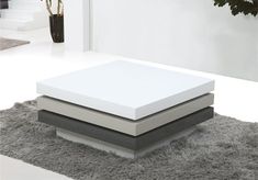 two mattresses sitting on top of each other in front of a white wall and carpet