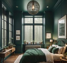 a bedroom with dark green walls and wooden flooring, along with a large bed