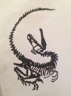 a black and white drawing of a lizard on a piece of paper with writing underneath it