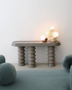 a table that has some lights on it in front of two chairs and a couch