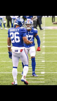 two football players are standing on the field