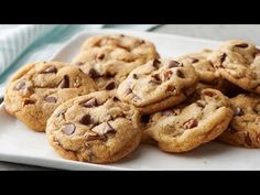 several chocolate chip cookies on a white plate