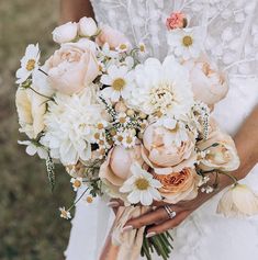 a bride holding a bouquet of flowers in her hands