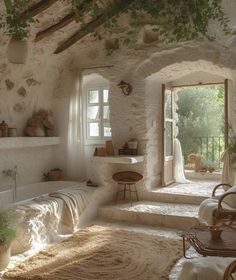 a bathroom with stone walls and flooring next to an open door that leads to a balcony