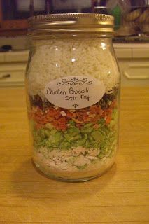 a glass jar filled with food sitting on top of a wooden table