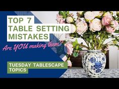 a vase filled with flowers sitting on top of a blue and white tablecloth covered table