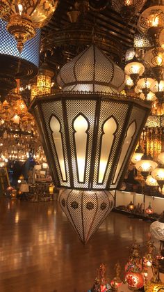 a large chandelier hanging from the ceiling in a room filled with lights and decorations