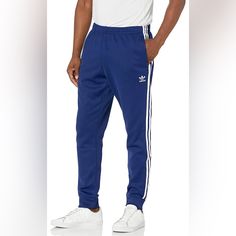 Slim Fit Drawcord On Elastic Waist 60% Recycled Polyester, 40% Cotton Interlock Front Zip Pockets Ribbed Cuffs Imported Never Taken Out Of Packaging Color Looks Slightly Darker Than Stock Photos In Real Life Cotton Pants With Three Stripes And Relaxed Fit, Cotton Loungewear Bottoms With Three Stripes, Relaxed Fit Cotton Sweatpants With Three Stripes, Cotton Joggers With Three Stripes In Relaxed Fit, Blue Athleisure Pants With Three Stripes Branding, Cotton Sweatpants With Side Stripes In Straight Leg, Cotton Sweatpants With Side Stripes, Cotton Straight Leg Sweatpants With Side Stripes, Blue Cotton Pants With Side Stripes