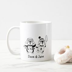 a white coffee mug sitting next to a donut on a table with the words save and jane printed on it